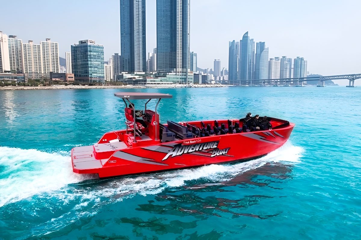 Adventure boat cutting across the sea by day