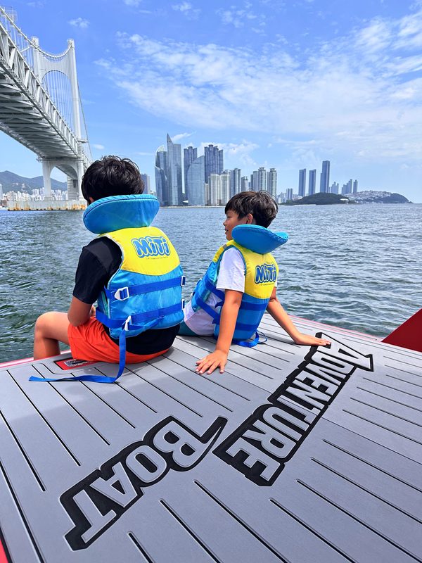 Children in life jackets on the boat