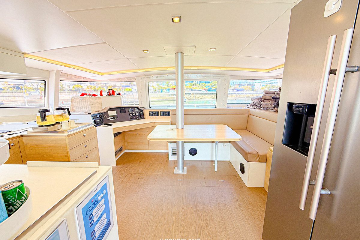 Interior of the BALI yacht with kitchen and sofa