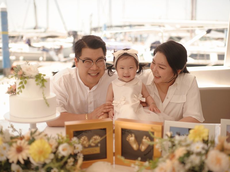 Family celebrating a first birthday on a yacht