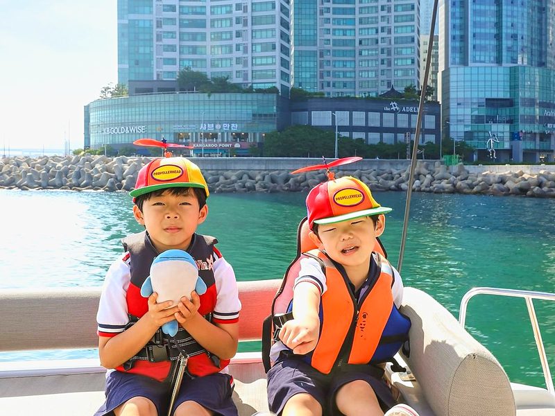 Children in life jackets sitting on the yacht