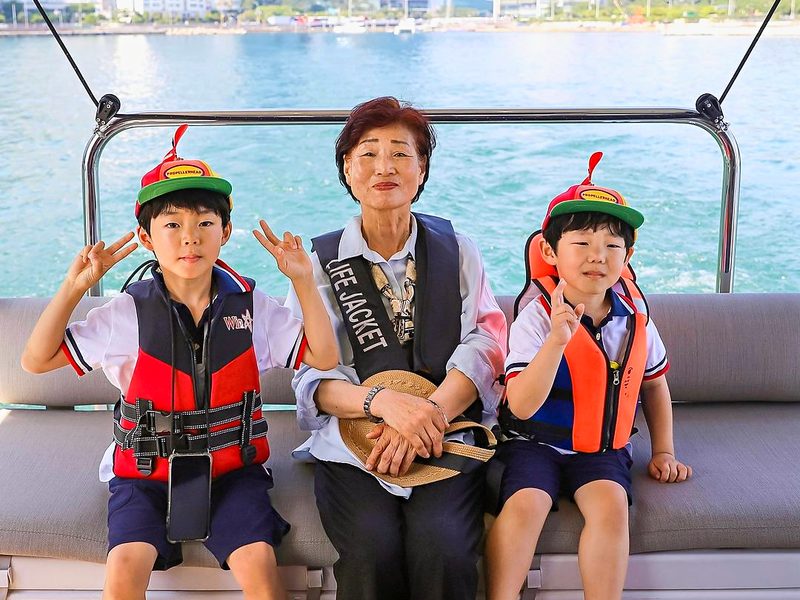 Family in life jackets sitting on the yacht