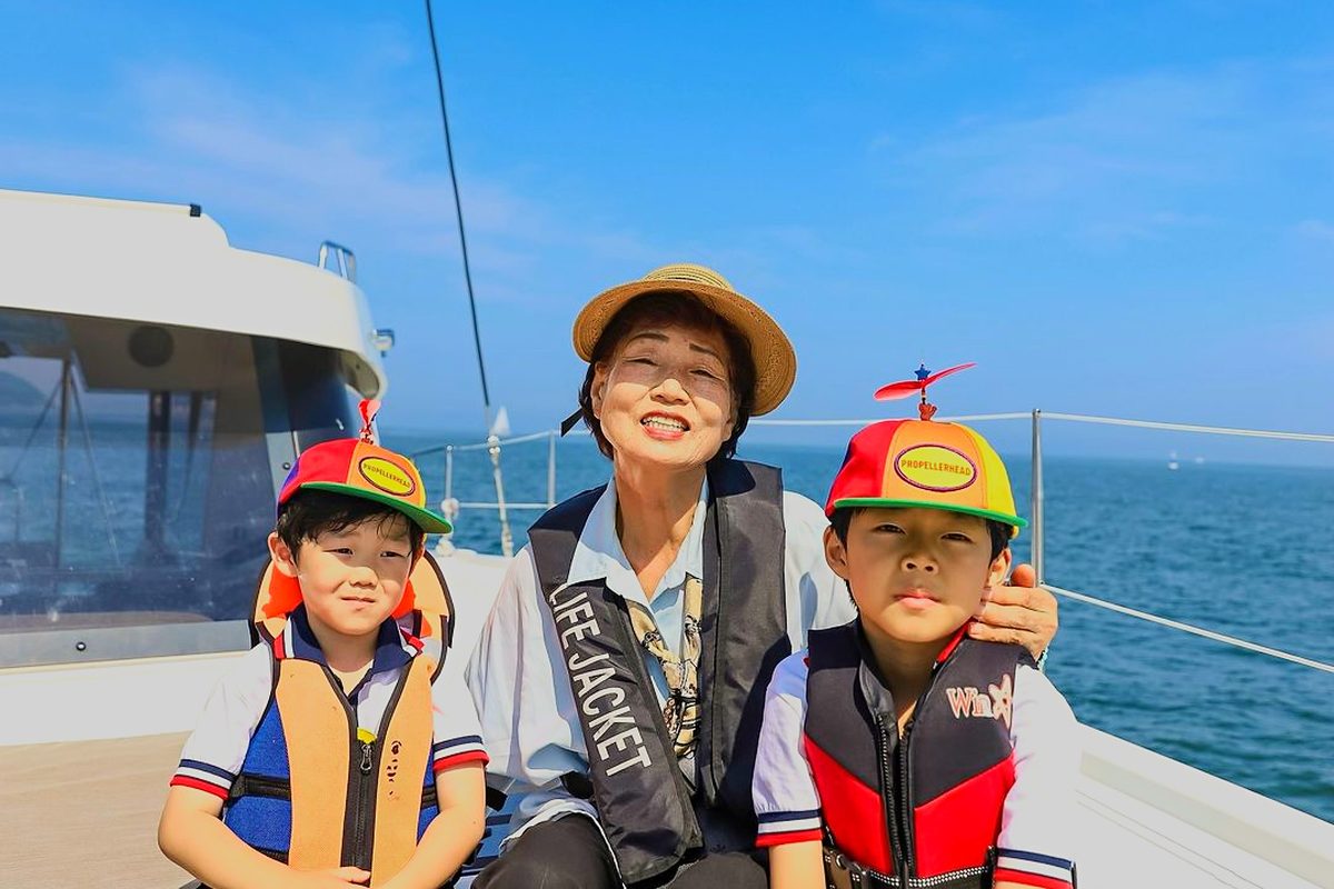 Family sitting on the yacht deck