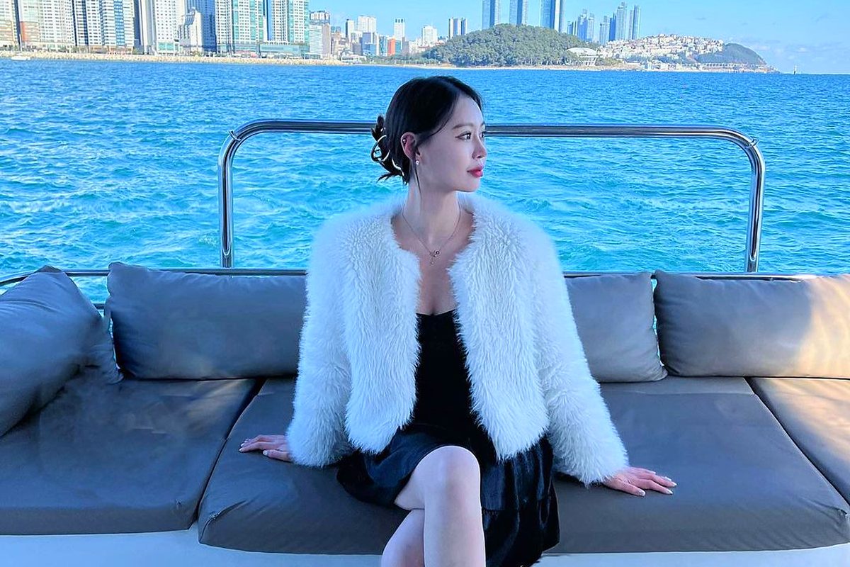 Guest on a deck sofa in front of Marine City